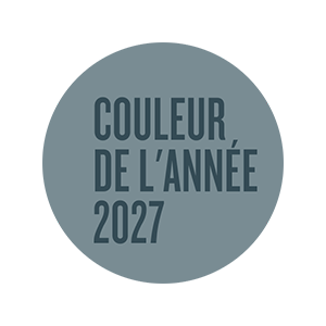 Circular graphic featuring the Valspar Color of the Year 2027 designation in Cottage Door blue-gray tones.
