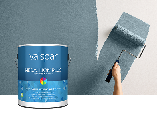 Valspar Reserve Interior Paint + Primer can displayed beside a paint roller coated in Cottage Door paint, showcasing premium interior application.