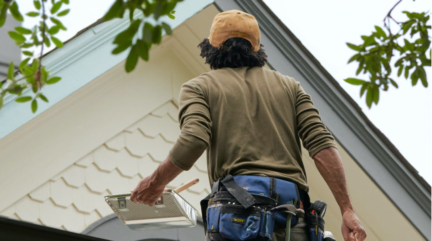 Professional Painter working on house